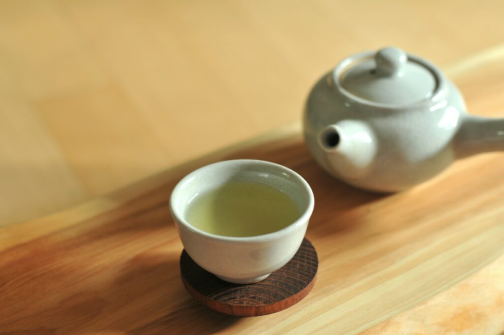 une tasse de thé vert et une théière